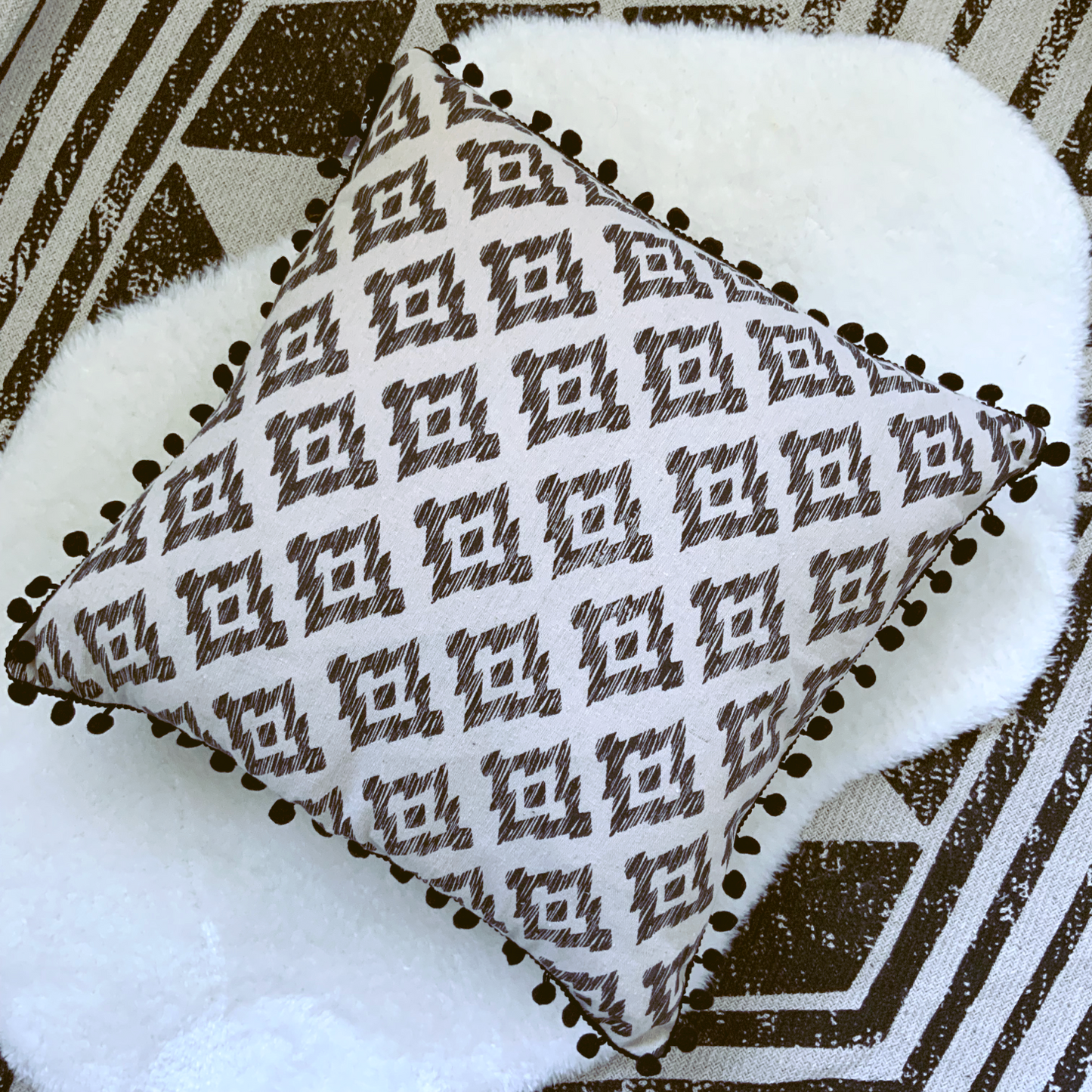 This Mia Aztec Cushion is perfect for updating any bedroom. Crafted from cream cotton, it features a black pom pom edging and a stylish Aztec print for a contemporary look. Soft and comfortable, with a polyester filling and measuring 45 x 45cm, this cushion is sure to bring a modern touch to your space and the perfect cushion for your bed or sofa. Available as a filled cushion.