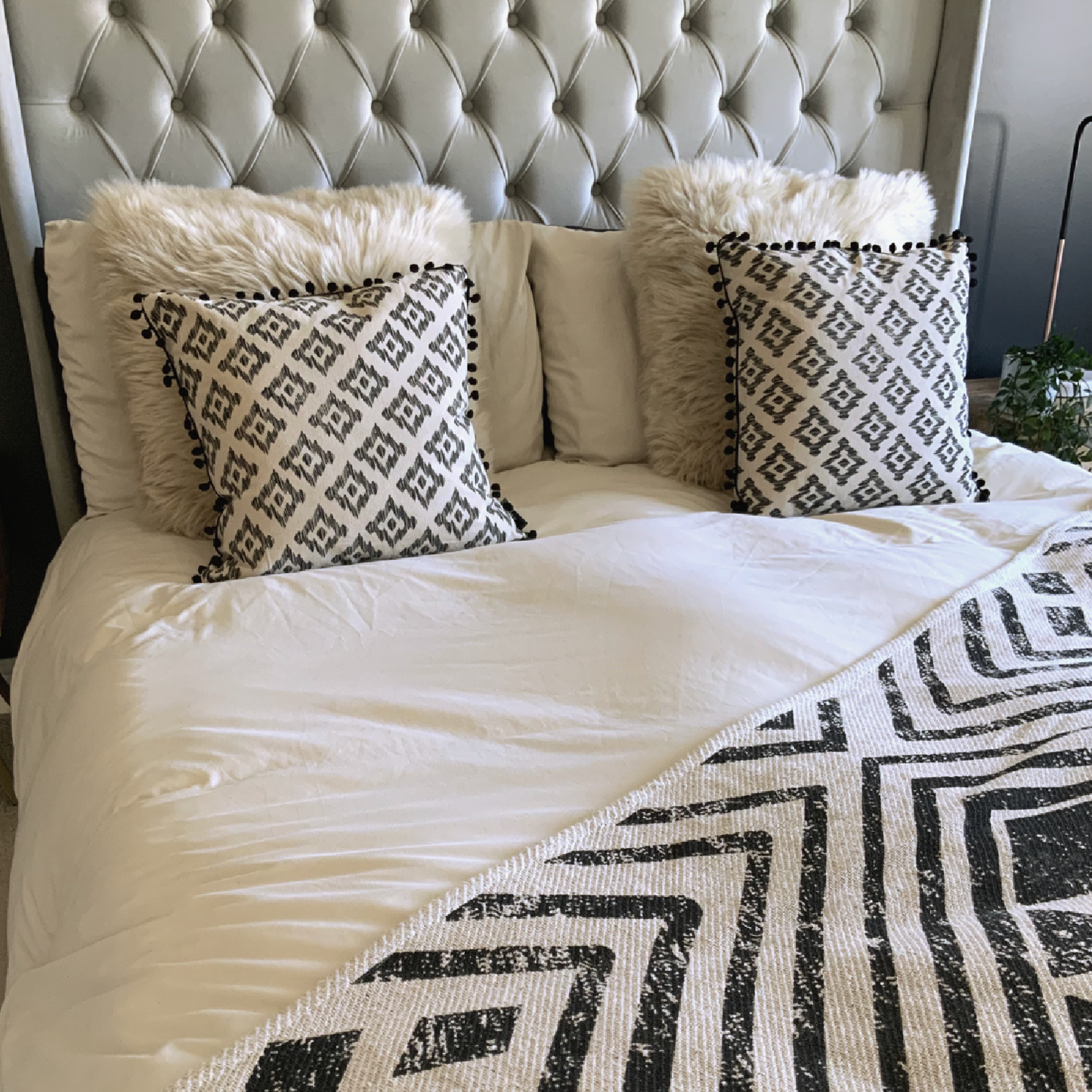 This Mia Aztec Cushion is perfect for updating any bedroom. Crafted from cream cotton, it features a black pom pom edging and a stylish Aztec print for a contemporary look. Soft and comfortable, with a polyester filling and measuring 45 x 45cm, this cushion is sure to bring a modern touch to your space and the perfect cushion for your bed or sofa. Available as a filled cushion.