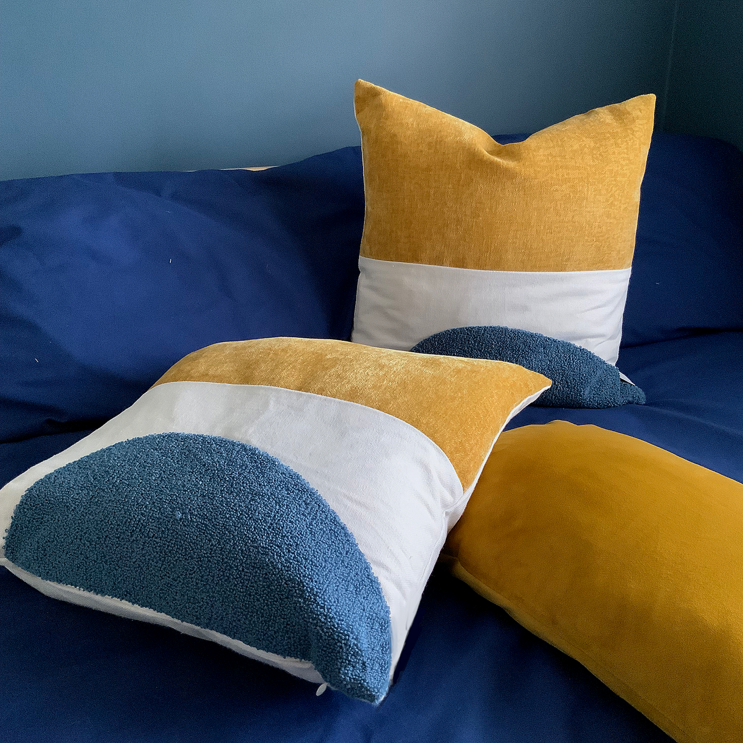 Mustard and blue cushion, velvet, canvas and wool texture finish.
