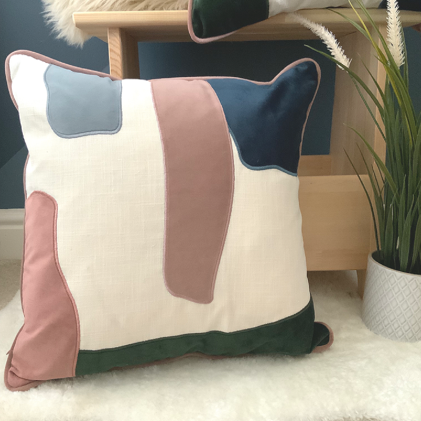 This Prem Abstract Cushion is perfect for achieving a contemporary décor in your home. Its unique design features pink, green, white and blue abstract pattern, and is crafted with high quality velvet with a contrast trim. It is feather filled and measures 45 x 45 cm, making it the perfect addition to your sofa, bed, or armchair. Add this statement piece to your home for a stylish finishing touch, the perfect cushion for your bed or sofa. Available as a filled cushion.
