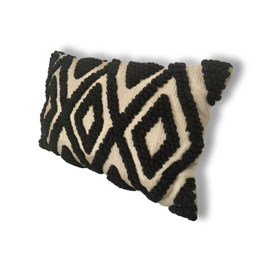 The Black Kiera cushion is a cotton, hand tufted, woven cushion. Exclusively designed by Cultured Home founder Pratisha. This statement pillow has a striking black tufted, diamond pattern, against a woven beige background, making it the perfect accessory to add a little flair to any bed, sofa or space. This is a highly quality, rustic cushion and dry clean only.  All cushions are handmade and can vary slightly in pattern and size from the images shown.   This cushion is size 30 x 50cm.