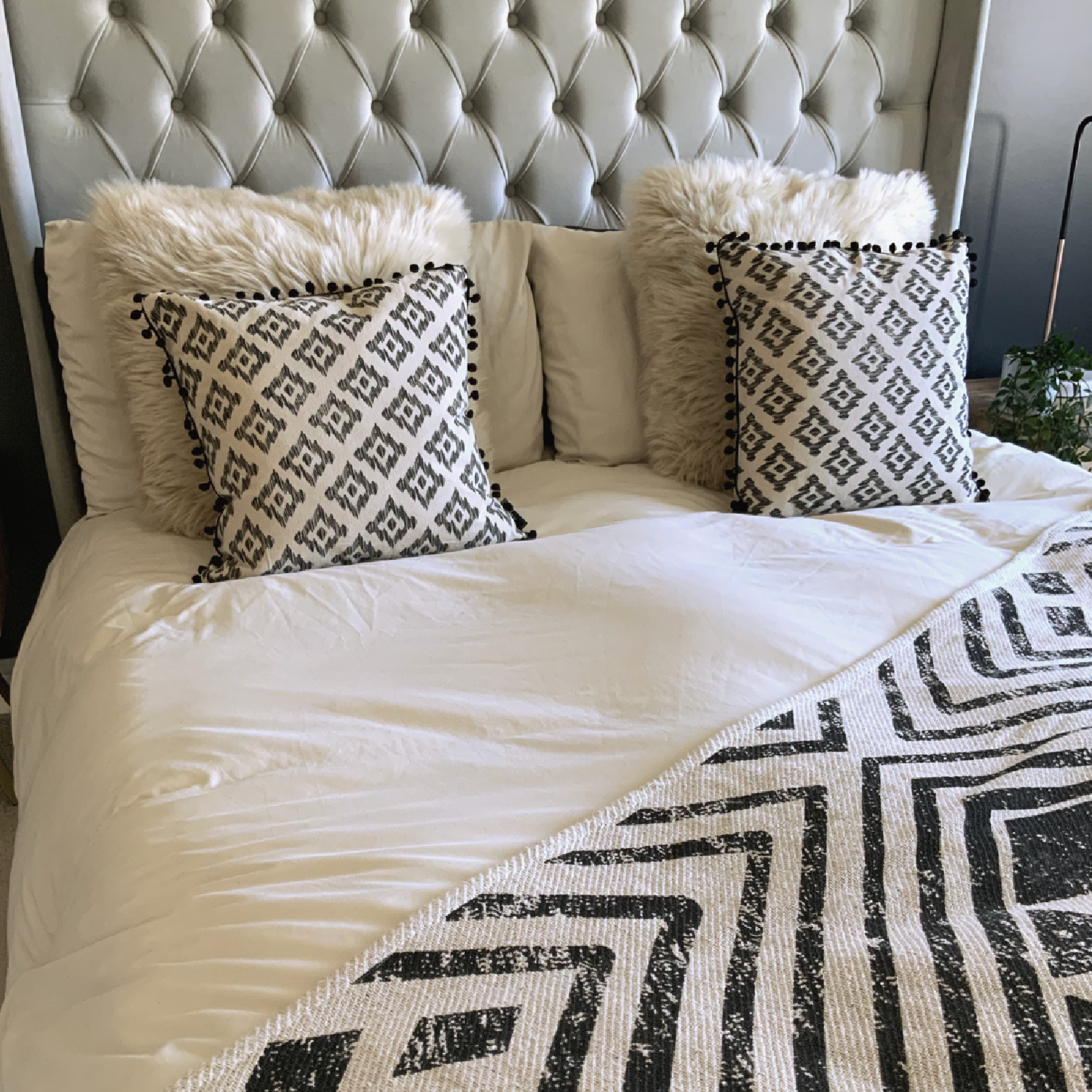 This Mia Aztec Cushion is perfect for updating any bedroom. Crafted from cream cotton, it features a black pom pom edging and a stylish Aztec print for a contemporary look. Soft and comfortable, with a polyester filling and measuring 45 x 45cm, this cushion is sure to bring a modern touch to your space and the perfect cushion for your bed or sofa. Available as a filled cushion. 