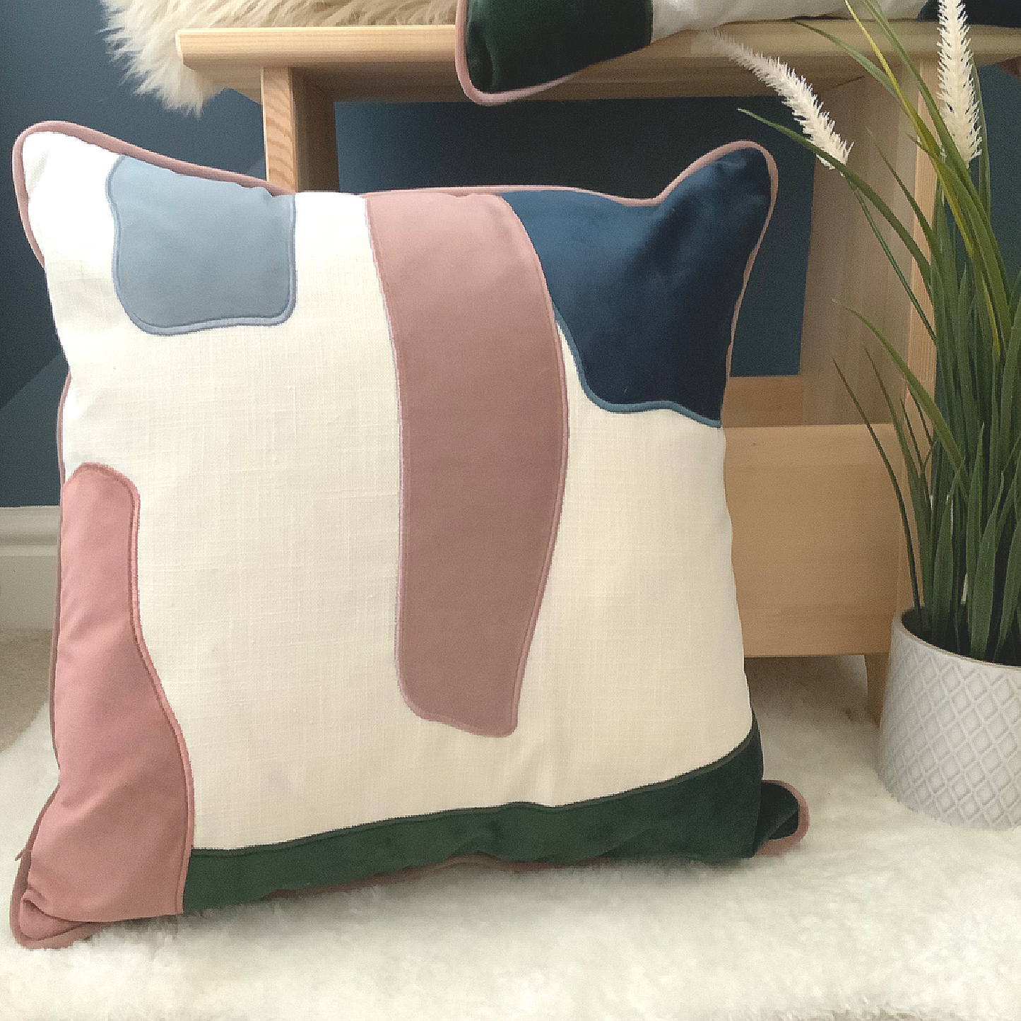 This Prem Abstract Cushion is perfect for achieving a contemporary décor in your home. Its unique design features pink, green, white and blue abstract pattern, and is crafted with high quality velvet with a contrast trim. It is feather filled and measures 45 x 45 cm, making it the perfect addition to your sofa, bed, or armchair. Add this statement piece to your home for a stylish finishing touch, the perfect cushion for your bed or sofa. Available as a filled cushion. 